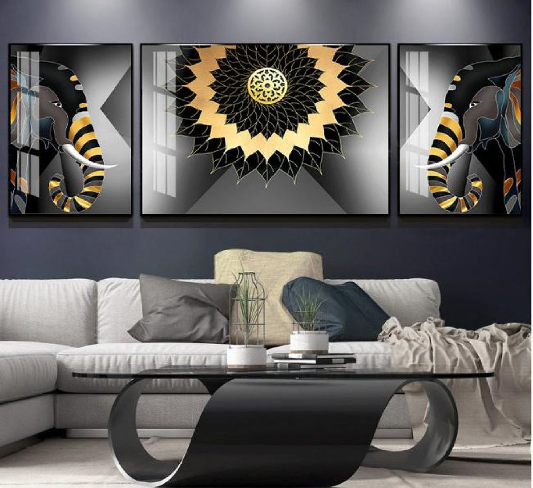 Three-piece set of a black and gold lotus mandala with sculpted petal flanks, above a grey sofa