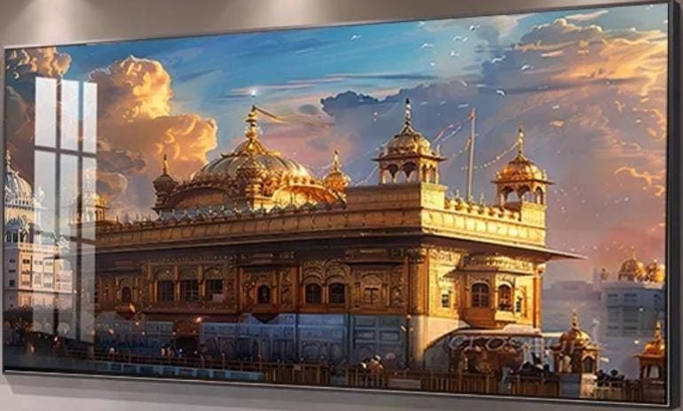 Harmandir Sahib, the Golden Temple, glowing gold under an evening sky of blue and apricot clouds, printed on glass in a dark frame